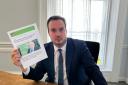 East Devon MP Simon Jupp pictured with the EDDC press release referring to the letter sent to lobby for swimming pool funding, which the council never applied for.
