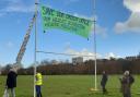 Exeter's Extinction Rebellion group installs a banner as part of its protest over approved plans for a 3G playing pitch on Flowerpot Playing Fields.