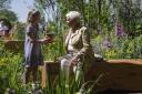 Dame Judi Dench and school competition winner Charlotte Crowe placed the Sycamore Gap seedling in The Octavia Hill Garden at Chelsea Flower Show