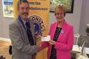 Heather Penwarden recieves a cheque from Honiton Lions Club.