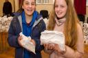 Jasmin Shackleford and Bethany Parsons were first in the queue at the Sidmouth Easter Bun giveaway. Ref shs 14 18TI 0406. Picture: Terry Ife