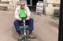 Steve Morris with his motorised buggy outside the Gateway Theatre Seaton