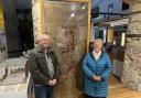 Lydia’s grandchildren, Barry Ebdon (the donor) and his cousin Marina Tressider with the Thomas Whitty Rug now on display at the Axminster Heritage Centre