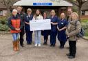 Chloe Burridge presenting her cheque to Seaton & District Hospital League of Friends trustees and Seaton Hospice at Home nurses