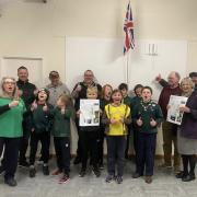 Nancy Craven, left; Cubs leader Tris Emmett, middle; Bernard Dunford and Ann Kelf from Seaton Visitor Care Trust second and third right; Scouts and helpers.

Cubs are holding the drawing