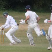 Sidmouth wicketkeeper Robbie Powell removes the bails