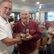 Senior's Captain Steve Thompson, on the left, presenting the winner Geoff Hughes with the Trophy