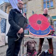 Peter Slimon, Chairman of the Royal British Legion Axminster Branch by Shed member and military veteran Patrick Daumann-Rattenbury and his assistance dog Dotty