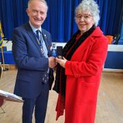 Rear Admiral Chris Snow presents the medal to Mrs Maria Johnsonia Johnson of Axmouth, (Seen here) the widow of the late Anthony Leonard